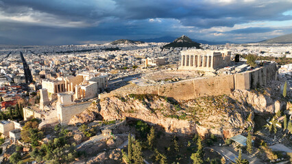 Fototapeta na wymiar Aerial drone dramatic shot above unique Acropolis hill and the Parthenon an Unesco world heritage site, Athens historic centre, Attica, Greece