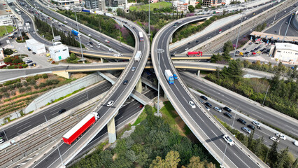 Aerial drone photo of multilevel bridge highway road interchange passing near urban residential...