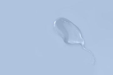 Trasparent smear in shape of spermatozoon on color background.Concept for fertilizatio