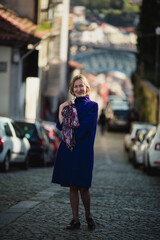 A woman walks down the street in Porto, Portugal.