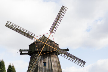 Old wooden wind mill in on a sunny day. Old traditional Dutch mill.