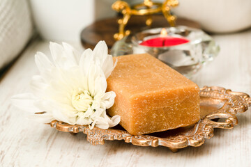 Natural soap on a tray with flower, spa concept