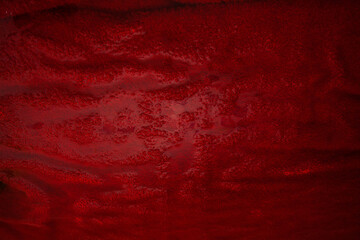A red fluffy towel lies underwater. Dark textured image for your creative design or unusual...