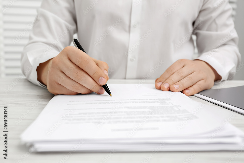 Poster Man signing document at wooden table, closeup