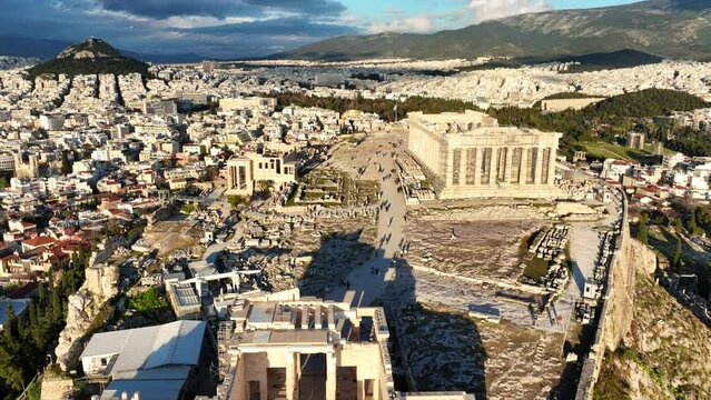 Aerial drone cinematic video of amazing Acropolis hill, the Parthenon and Propylaea entrance above Areopagus hill, a masterpiece of ancient world, Athens historic centre, Attica, Greece
