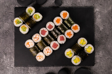 Sushi rolls set on dark background. Japanese and asian food concept