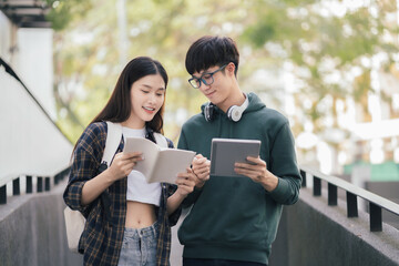 Asian students joining study book reading together.