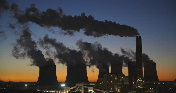 Smoke stacks at coal-fired power station at dusk
