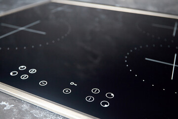 Modern induction electric hob cooker with control panel buttons. Electric hob detail closeup. Stove...