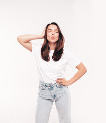 Obraz premium Young beautiful woman. Trendy carefree model in casual summer white T-shirt and blue jeans. Positive female isolated on white in studio. Cheerful and happy. Copy space, mockup. Makes duck face