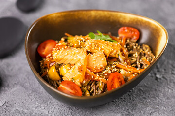 Udon stir-fry noodles with salmon and vegetables. Asian cuisine