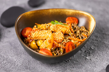 Udon stir-fry noodles with salmon and vegetables. Asian cuisine
