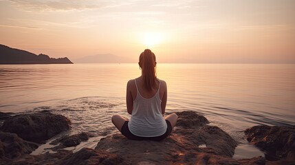 Young woman practicing yoga near the sea in summer. Harmony and meditation concept. Healthy lifestyle, enjoying life, summer fun, self care, mindfulness concept