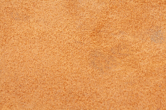 Light beige matte background of suede fabric, closeup.