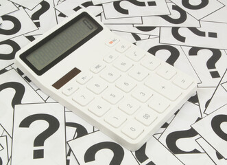 White calculator on question marks background. 