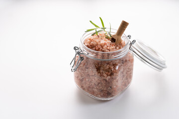 Himalayan pink salt on glass of jar isolated on white background with copyspace