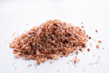 Himalayan pink salt isolated on white background with copyspace