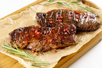Aged barbecue beef steak close up on wooden background. banner, menu.
