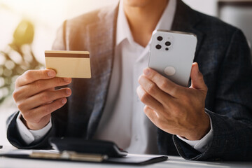 Women holding credit card and using smartphones at home.Online shopping, internet banking, store online, payment, spending money, e-commerce payment at the store, credit card, concept