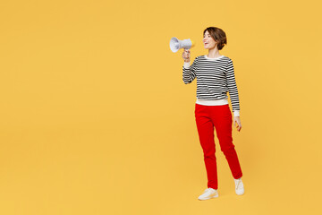 Full body young woman wears casual black and white shirt hold in hand megaphone scream announces discounts sale Hurry up isolated on plain yellow color background studio portrait. Lifestyle concept.