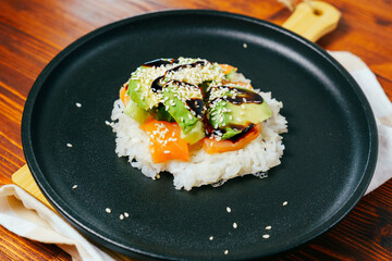 Sushi waffle is a cooking process. Culinary trend made with crispy rice waffles and sprinkled with salmon, cucumber