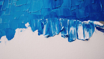 Abstract painting. Creative process. Artistic hobby. Closeup unfinished artwork with blue paint...