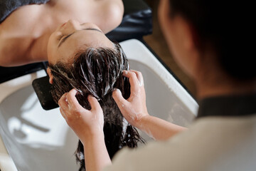 Young woman getting deep cleanse procedure in beauty salon