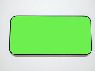 Smartphone with green screen in tecnology concept.