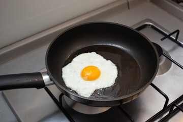 The egg is frying in the frying pan