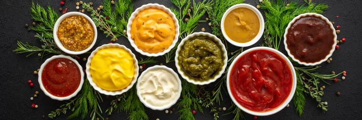 Fotobehang Different types of sauces in bowls with seasonings banner, rosemary and dill, thyme and and peppercorns, top view, copy space © pundapanda