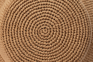 A brown isolated hat made of raffia on a white background. Hats mockup, no brand, top view presentation