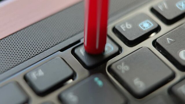 A man or woman presses the F5 key on a laptop. macro photography.