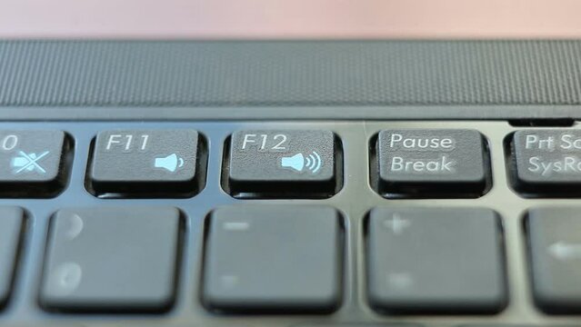 A man or woman presses the F12 key on a laptop. macro photography. looped video.
