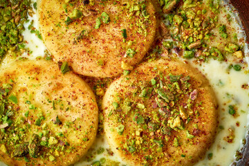 Close-up of cheesecakes syrniki with custard in a plate on a wooden background.