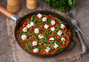 Greek Green beans stew Fasolakia. Tender green beans braised in olive oil and tomato sauce served...