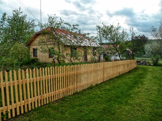 Fototapeta na wymiar We made a new wooden fence in the village