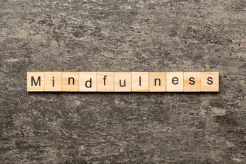 mindfulness word written on wood block. mindfulness text on table, concept