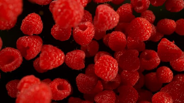Super Slow Motion Shot of Flying and Rotating Fresh Raspberries at 1000fps.