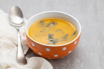 Vegetable cream soup with spinach in bowl