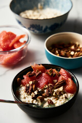 Overnight oats with milk and greek yogurt. healthy breakfast with nuts with grapefruit, honey and cinnamon