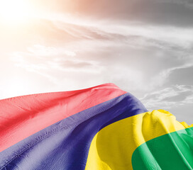 Mauritius national flag cloth fabric waving on beautiful sky grey Background.