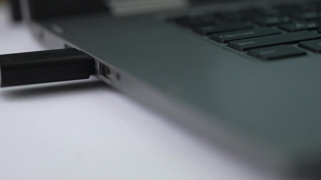 Closeup of inserting USB DRIVE into a laptop