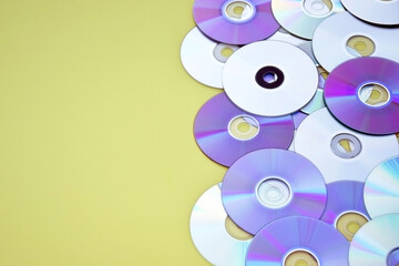 Lots of old CDs are laid out as a background.