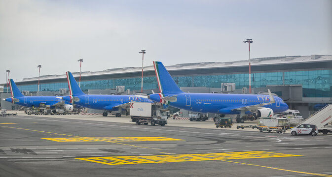 ROME, ITALY - March 31, 2023: 3 Alitalia aircrafts docking at Fiumicino International Airport "Leonardo da Vinci".