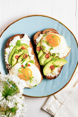 An avocado cutted on a pink background. High contrast