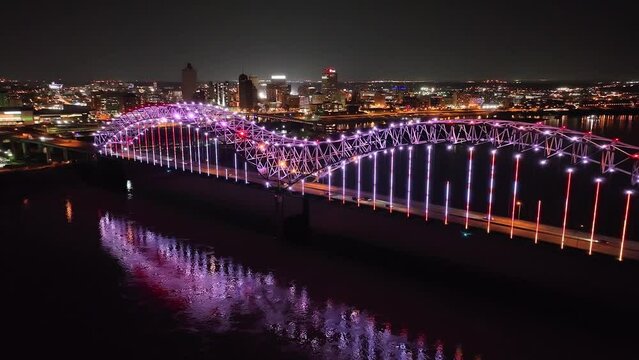 Hernado De Soto bridge in Memphis, Tennessee with illuminated Mighty Lights at night with drone video moving forward.