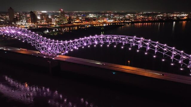 Hernado De Soto bridge in Memphis, Tennessee with illuminated Mighty Lights at night with drone video panning right to left.