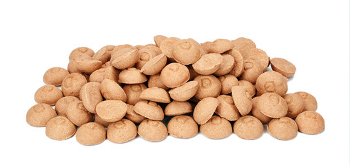 Brown crunchy organic kibble pieces for dog feed heap isolated on white background. Healthy dry pet food