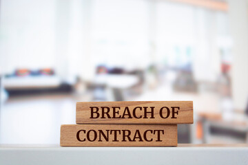 Wooden blocks with words 'BREACH OF CONTRACT'.