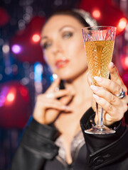Beautiful, brunette with a glass of wine in her hands. She's in a leather coat and black sexy lingerie
